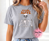 Staying Alive Skeleton Coffee Shirt | Funny Sarcastic Adult Unisex Tee | Caffeinated Skeleton Graphic T-Shirt | Retro Coffee Lover Gift